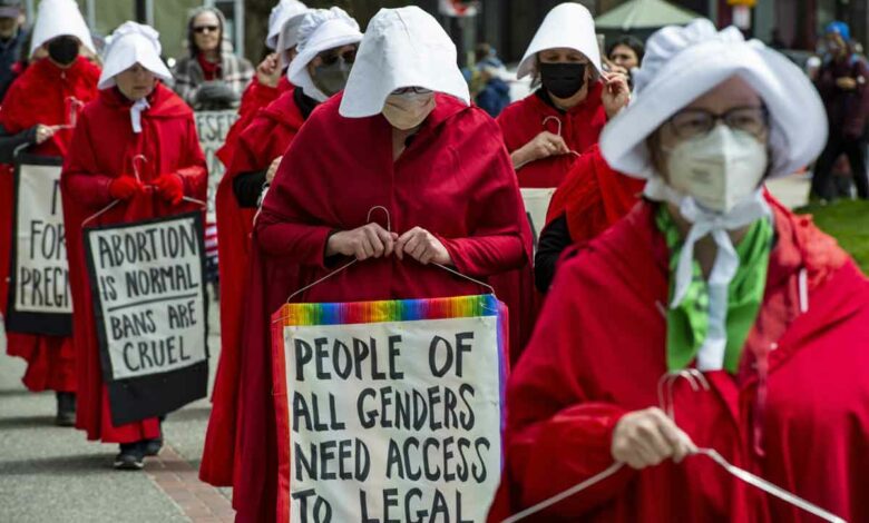Members of the Boston Red Cloaks march to the State House to protest the overturning of Roe vs. Wade and call for support of pro choice for all women in the US in Boston, Massachusetts on May 7, 2022. Multiple US organizations that support abortion rights called for nationwide protests on May 14, after a leaked draft opinion showed the US Supreme Court poised to overturn its landmark Roe v. Wade decision. (Photo by Joseph Prezioso / AFP)