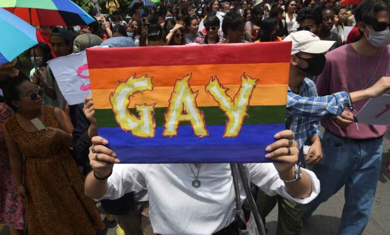 Ein Mitglied der Lesben-, Schwulen-, Bisexuellen-, Transgender-, Intersex- und Queer-Gemeinschaft (LGBTIQ+) hält während einer Pride-Parade in Kathmandu am 11. Juni 2022 ein Plakat mit der Botschaft „Schwul“ in der Hand. (Foto von PRAKASH MATHEMA / AFP)