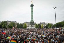 Participants gather at the Place de la bastille, in Paris, during the annual Pride Parade on June 25, 2022. The Inter-LGBT association who is organising the march say that their aim is to protest against transphysical speech, which they maintain is too often ignored by public authorities. (Photo by Alain JOCARD / AFP)