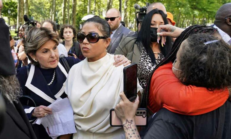 R&B singer R. Kelly's victims Lizzette Martinez (C) and Jovante Cunningham (R) talk to the press following the sentencing hearing at Brooklyn Federal Court in New York, on June 29, 2022. Disgraced R&B singer R. Kelly was sentenced to 30 years behind bars on June 29 for leading a decades-long effort to recruit and trap teenagers and women for sex. (Photo by TIMOTHY A. CLARY / AFP)
